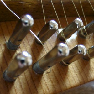 A sharp bend is put into the wire to prevent it from slipping out of the tuning pin hole