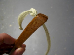 The hair is first put in the slot on one end, then stretched into the slot on the other end