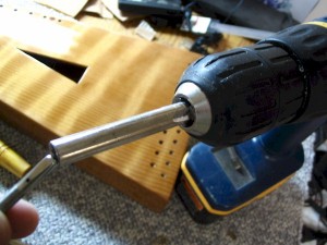 An old tuning wrench was modified into a tuning pin driver for use in a cordless drill