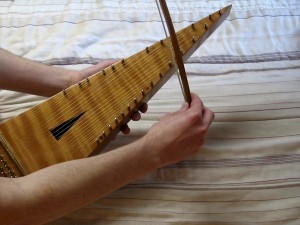 The bowed psaltery is played along the sides of the instrument