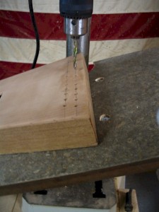 The table of the drill press is tilted 15 to drill the holes for the tuning pins