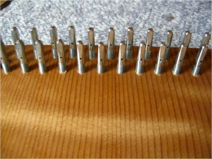 An overall look at the tuning pins before the strings are wound on them