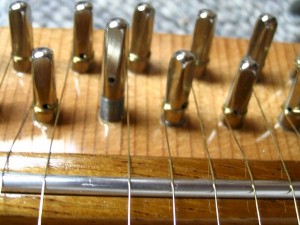 The tuning pin will begin higher than the rest, and will end up even as the string is wound on