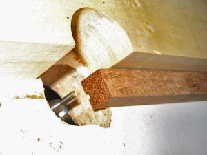 A 1/8" straight-cut router bit is used to make the slot for the bridge saddle