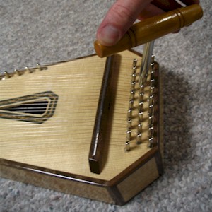 A special tuning wrench fits the tuning pins at the base of the psaltery